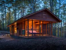 Wood Cabin With Screened Porch at Dusk