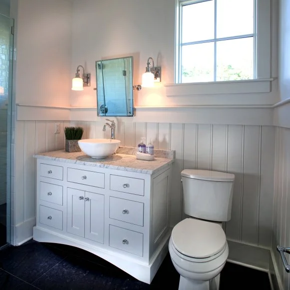 White Bathroom With White Vanity and Dark Tile Floor