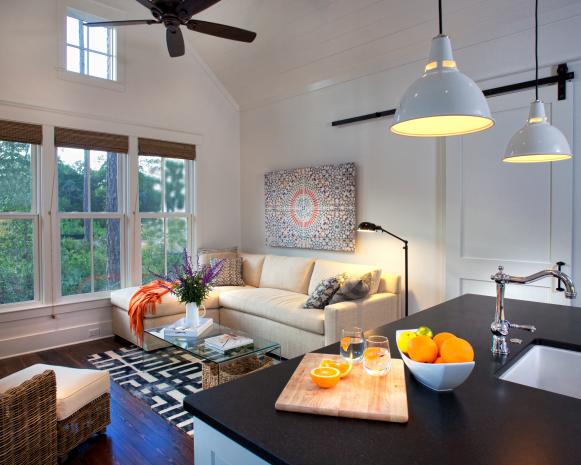 White Living Room and Kitchen With Vaulted Ceiling and Windows