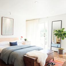 Bright White Master Bedroom With Colorful Rug