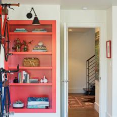 Vibrant Red Bookshelf Pops in Crisp White Bedroom