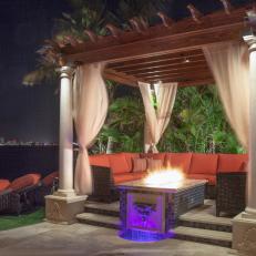 Oceanside Pergola Features Chic Sectional, Fire Table & Elegant Draperies