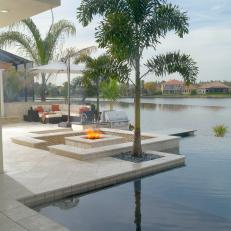 Chic Waterfront Patio Features Retreat-Like Infinity Pool, Swim-Up Bar & Lounge Areas