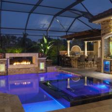 Luxurious Patio Living Space Features Infinity Spa, Fireplace & Television Above Outdoor Bar