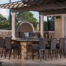 Handsome Outdoor Kitchen Features Espresso Seating & Limestone Bar
