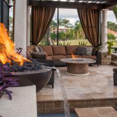 Fire Table & Bowl Warm A Luxurious Outdoor Living Space Featuring Elegant Curtains & Sofa