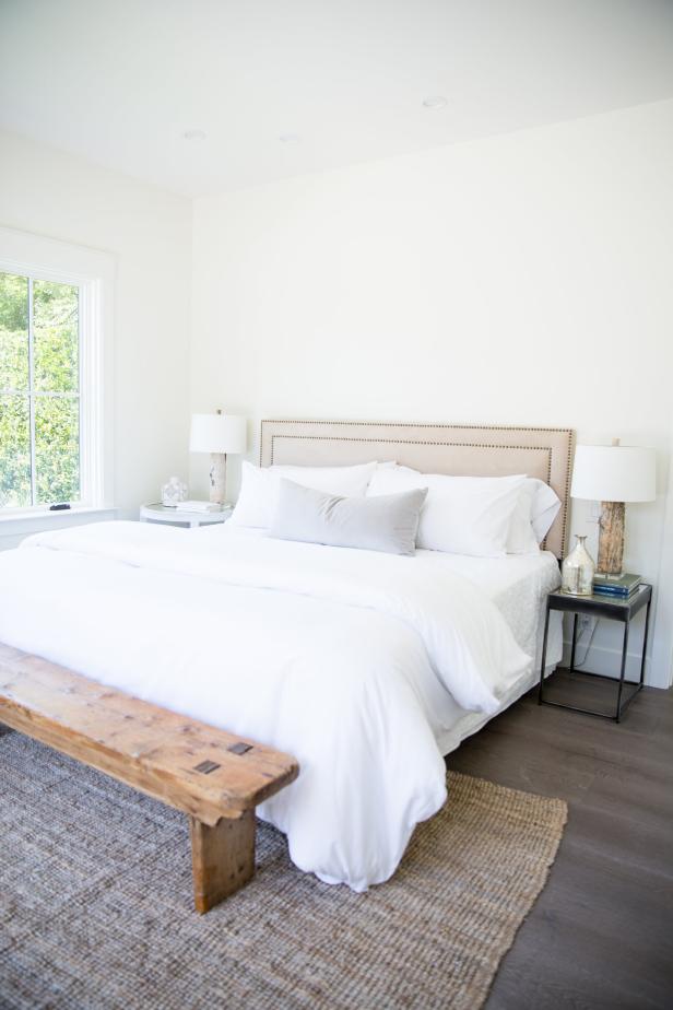 White Bedroom With White Bedding and Neutral Area Rug