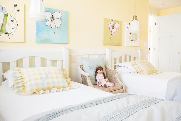 Girls' Light Yellow Bedroom With White Beds and Yellow Plaid Pillows