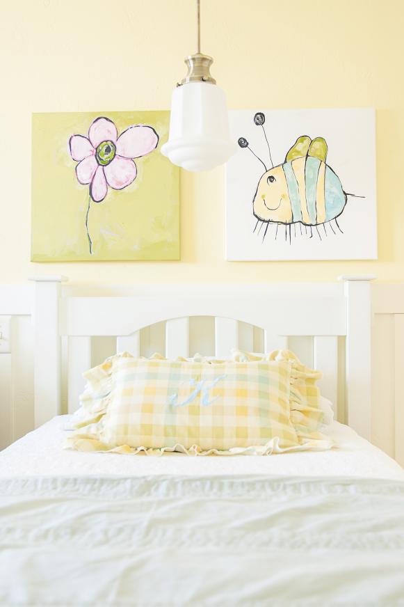Kids' Yellow Room With White Bed, Yellow Plaid Pillow and Kid Art