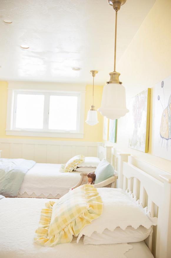 Kids' Yellow Room With Two White Twin Beds and Two Pendant Lights
