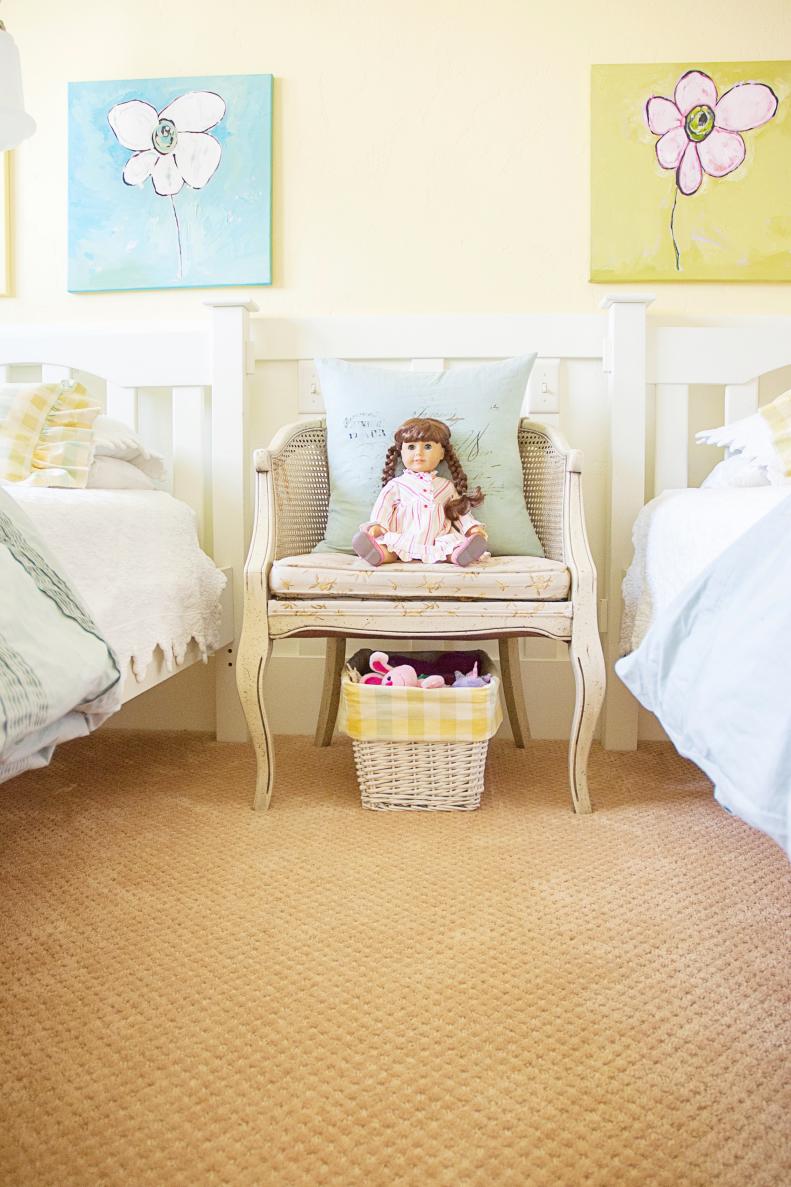Antique White Chair With Doll in Girls' Pale Yellow Bedroom