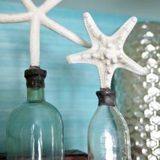 Starfish Poised on Bottles for a Coastal Look