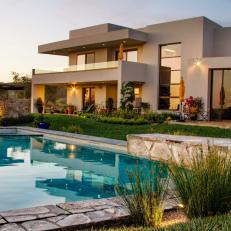 Backyard and White Home Exterior With Pool
