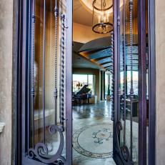 Home Entry with Glass and Wrought Iron Door, Featuring Custom Tile Inlay on the Floor