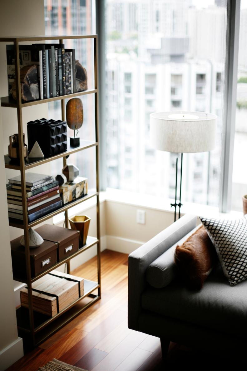 Neutral Living Space With Metal Bookcase & Large Windows