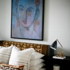 Midcentury Bedroom Features Upholstered Bed & Framed Art