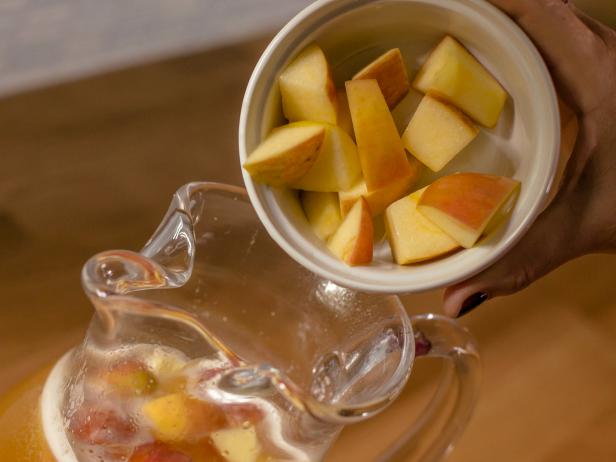 Chop two cups of fresh apples into cubes and place in the pitcher, then refrigerate for two hours if possible- this allows the flavors to mingle.