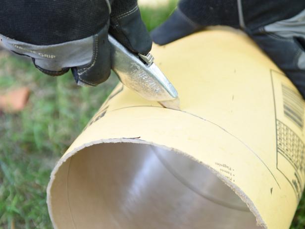 Measure, then mark the concrete form at 11 inches high. Using a utility knife, cut the form to size.