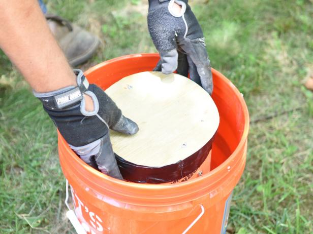Lower the form down into the bucket, so that itâ  s resting on top of the 4 inch layer of concrete. Press down or place something heavy on top to limit movement while you finish pouring concrete.