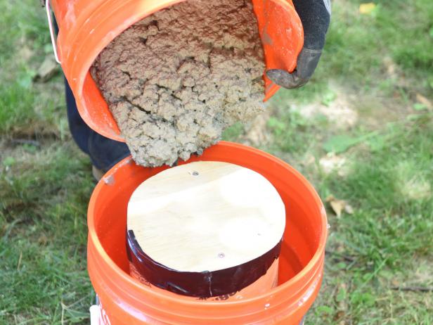 Continue adding concrete around the edges and shake bucket to agitate concrete â   this will help remove any bubbles from the mixture. Run a scrap 2x4 or trowel along the top of the bucket to smooth mixture. Let this set for at least 24 hours.