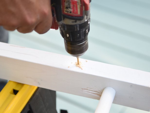 Pre-drill holes in the ladder with an appropriate size bit and install eye bolts on each corner.