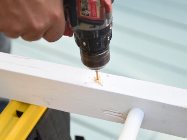 Pre-drill holes in the ladder with an appropriate size bit and install eye bolts on each corner.