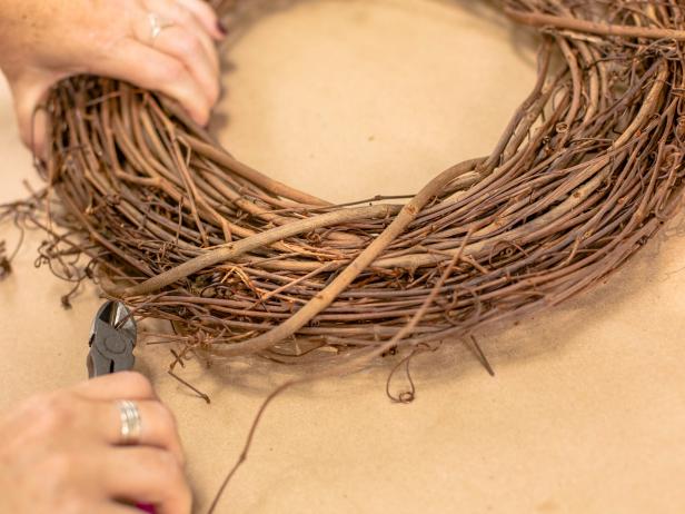 Using wire cutters trim up any excess or protruding vines so the wreath will have a clean circular shape.