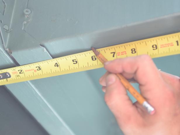 Using a tape measure and pencil, mark where you would like to hang the screen, based on your exterior, available seating and where the projector will be placed.
