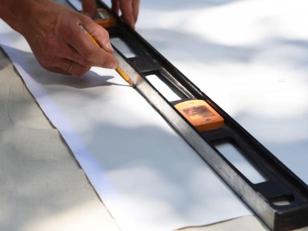 Use a heavy duty tape that is recommended for outdoor use. Lay the projection screen out face down on a clean, flat surface. Remove the adhesive backing and attach the hook side of the tape to the top edge of the screen, then trim to size.  Repeat this along the bottom edge of screen. Next, using a pencil and straight edge, measure and mark 5Â½â from the top and bottom edge of the screen- making a light line across the screen. Using this line as a guide, add the loop tape to the top and bottom and then trim to size.