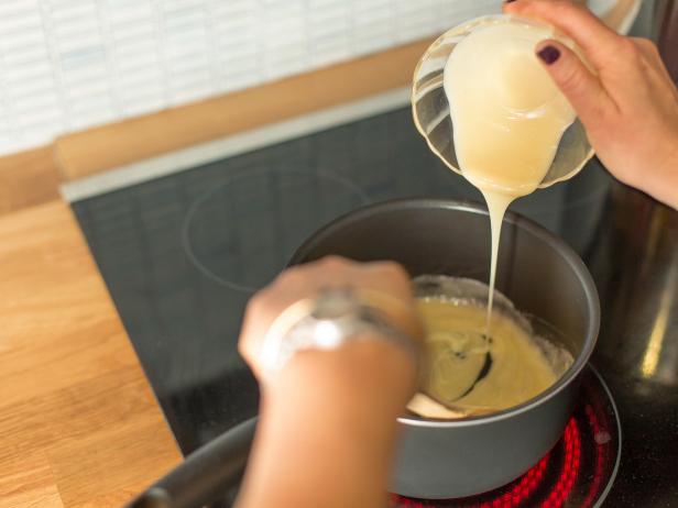 In a medium saucepan, melt half a stick of butter, then add quarter cup flour and a half a cup of condensed milk. Stir over medium heat.