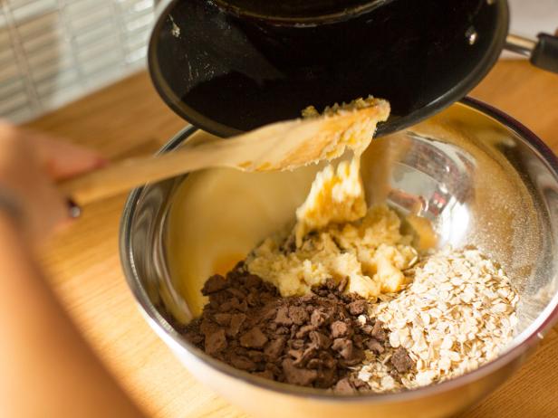 Once melted mixture has cooled, spoon it into the bowl with oats and graham cracker, then stir until well blended.
