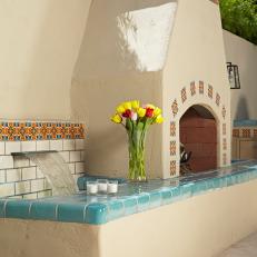 Stucco Fireplace and Water Feature Trimmed With Spanish Tile