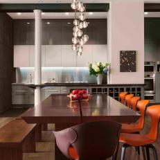 Loft Dining Area Boasts Modern Orange Chairs