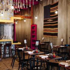 Dining Room of a Mexican Restaurant Featuring Black Spindle Chairs and Repurposed Tables