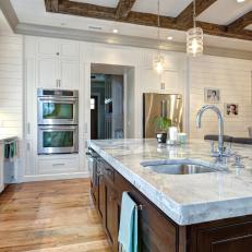 Contemporary Kitchen with Reclaimed Wood Beams and Floors Plus Marble-topped Island