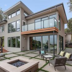 Contemporary Home Features Concrete and Grass Backyard