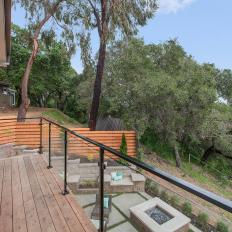 Balcony View of Backyard With Concrete Fire Pit 
