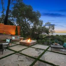 Concrete Grid Patio With Square Fire Pit and Brown Wicker Furniture