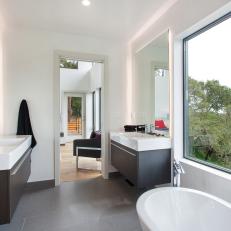 Modern Bathroom With Double Vanities and Large Window 