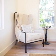 White Living Space with Neutral Upholstered Chair