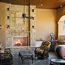Neutral Outdoor Living Room With Stone Fireplace