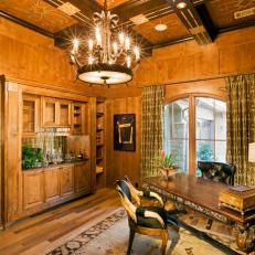 Brown Wood Paneled Home Office With Chandelier