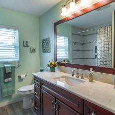 Green Transitional Style Bathroom With Wood Vanity And Mounted Light Fixture 