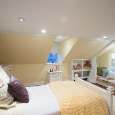 Teen Bedroom With Recessed Lighting, Sloped Ceilings & Soft Yellow Walls