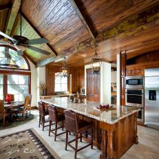 Ranch Kitchen with Vaulted Plank-and-beam Wood Ceilings, Carved Marble Island and Unique Rug