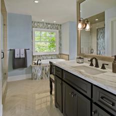 Soft Blue Bathroom With Mosaic Tile, Soaking Tub & Single Vanity