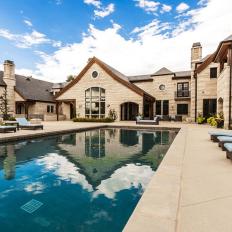 Pool and Patio With White Home Exterior