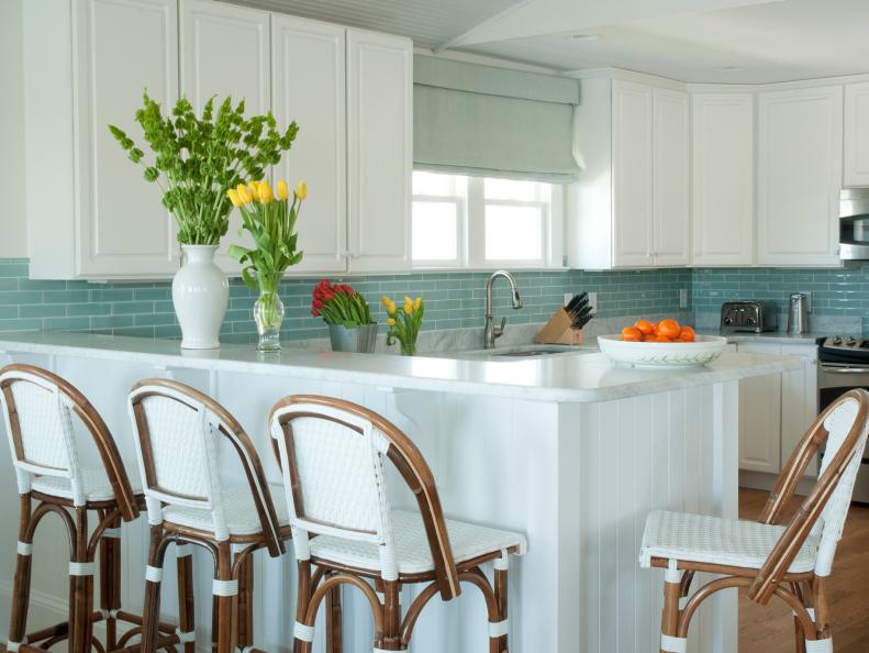 Kitchen With White Cabinets, Blue Tile Backsplash and Wood Barstools