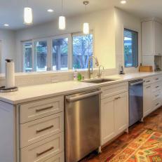 White Kitchen Peninsula With Stainless Steel Appliances