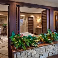 Tropical Living Area With Wood Shutters and Many Plants